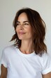 © VISUAL BACKGROUND - A woman with brown hair and white t - shirt.