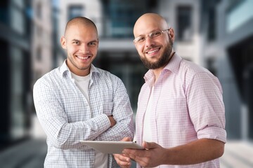 Poster - Two happy business colleagues standing near office,