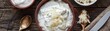 © Media Srock - A variety of white and black bowls filled with different types of food. The bowls are arranged in a row, with some containing cheese and others containing cream. Scene is one of abundance and variety