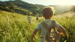 © OHMAl2T - children running through a green meadow on a mountain background on a sunny day