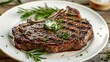 © matpit73 - A juicy perfectly grilled ribeye steak with char marks with fresh rosemary and a pat of herb butter on wooden table.