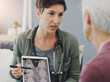 © Leffy/peopleimages.com - Senior woman, doctor and brain scan with tablet, xray and MRI results in hospital with surgery planning. Healthcare, CT and anatomy analysis for dementia test with talk and wellness consultation