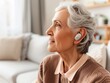 © Viktorikus - Senior Woman Enjoying Music with Modern Wireless Earbuds at Home