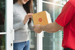 © Pormezz - Delivery service concept, A client received shopping bags from the delivery man at home.