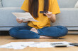 © Pormezz - Financial loan and debt concept, Women holding mockup credit card and invoice during calculate monthly expense.