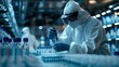 © kanesuan - A healthcare worker wearing protective gear and examining virus samples in a laboratory setting, highlighting the research environment.