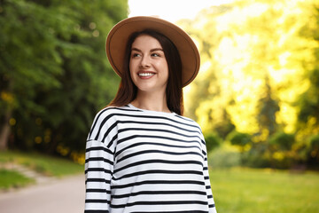 Poster - Portrait of smiling woman in hat outdoors. Spring vibes