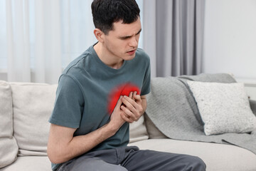 Canvas Print - Man suffering from pain in chest at home. Heart disease