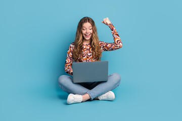 Poster - Full length portrait of nice young girl laptop raise fist wear top isolated on blue color background