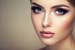 © Adisorn - A delicate, almond-shaped female eye with lush lashes and subtle makeup, gazing upward with a soft, serene expression, against a gentle, creamy background.