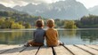 © liliyabatyrova - Two young boys are sitting on a dock by a lake, looking out at the water