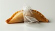 © Farm - A single, golden,  pastry is sealed in a clear plastic bag.