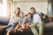 © StarDweller/peopleimages.com - Portrait smile, family and children on couch with bonding time, healthy relationship and relax together in home. Happy kids, parents and love on sofa with security, safety and weekend in living room