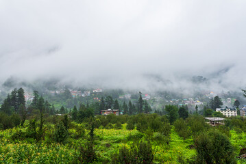 Wall Mural - Old Manali town shrouded in misty clouds in Monsoon season. It is a popular Heaven for back packers and nature lovers for its natural beauty of Himalayas in Kullu region.