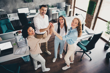 Sticker - Photo of successful young joyful people colleagues working together hands touch high five workspace indoors