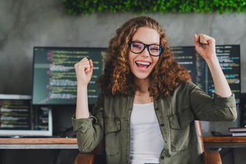 Photo of lovely excited glad woman software developer sitting armchair comfortable workspace workstation indoors