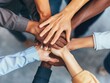 © Alexander Chaykin - Group of people joining hands, unity and solidarity concept