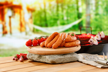 Sticker - Grilling sausages and vegetables in garden in summer time concept and copy space for food and products.