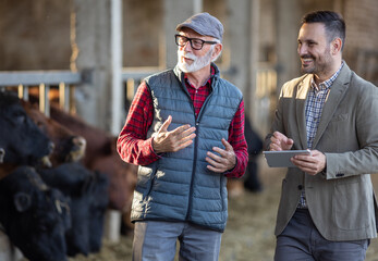 Canvas Print - Businessman and farmer talking on ranch