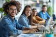 © Vera - group of diverse business people working together with laptops and digital marketing tools, creating a website design for their target audience. They are smiling, happy