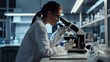 © pier - female scientist examining samples with electron microscope in lab
