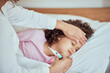 © SneakyPeakPoints/peopleimages.com - Mom, sick girl and tool for fever in home, virus and monitor temperature for covid infection. Mother, daughter and childcare for cold or flu in bedroom, thermometer and symptoms of sinus bacteria