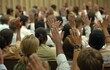 © Maxim Borbut - Hands raised to ask a question and respond to a speaker in a meeting room seminar