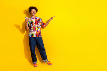 Wall Mural - Full body portrait of nice young man phone direct finger empty space wear shirt isolated on vivid yellow color background