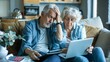 © Daniel - Worried senior retired husband and wife stressed about financial crisis thinking on problems, money troubles, overspending, sitting on home couch at laptop, calculator, paper bills, holding head