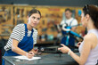 © JackF - Young female worker signs agreement with female client at bicycle repair service