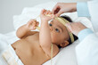 © KayJoint/peopleimages.com - Measuring tape, baby and hands of doctor for growth, brain or development for children. Pediatrician, infant or patient and wellness for healthcare in clinic and trust for professional care and help