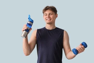 Sticker - Sporty young man with bottle of water and dumbbell on light background