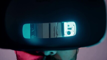 Poster - A man with a beard wears a VR headset, illuminated in pink and blue lighting.