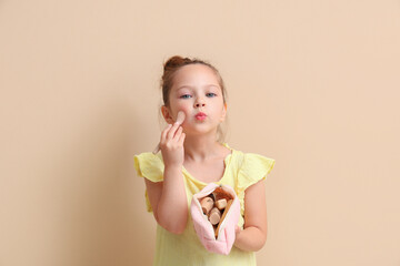 Sticker - Cute little girl with cosmetic bag and makeup brush on brown background