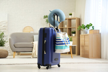 Sticker - Neck pillow on suitcase with beach bag in bedroom. Travel concept