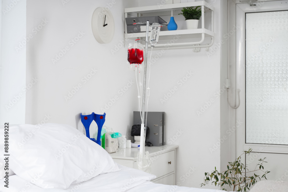 Bed with drip stand in hospital ward