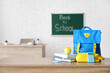 © Pixel-Shot - Apple, books, schoolbag and stationery on desk in classroom. Back to school concept
