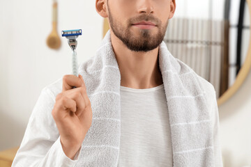 Poster - Bearded young man with razor at home, closeup