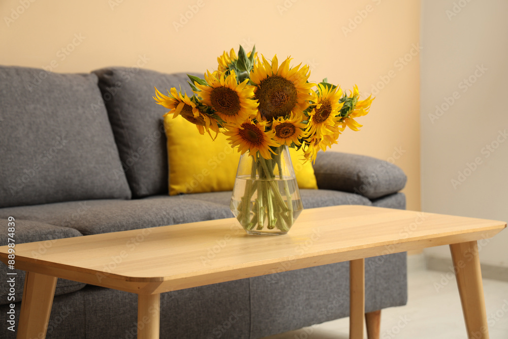Cozy sofa and coffee table with sunflowers in living room