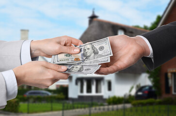 Wall Mural - Client giving money to real estate agent against beautiful house, closeup