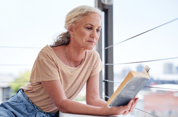 Poster - Woman, book and reading on patio for retirement, relax and peace in apartment or home. Senior female person, novel and morning on balcony for calm, knowledge and fiction for story and fantasy