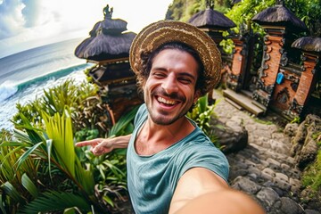 happy man taking selfie self-portrait in bali, indonesia. young tourist take funny selfie for travel