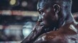 © Berkah - A thoughtful boxer looking away before a fight.