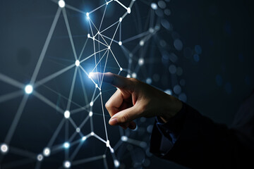 A hand touches light points in the direction of a technology network and interconnected lines. Symbolizing the concept of digital transformation, blockchain technology, and future networks.