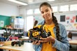 © CozyNessAI - Young happy college student holding her robotic toy in a robotics classroom at school. Students build electric toys and robots. Science and Technology in Education.