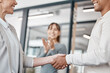 © peopleimages.com - Business people, meeting and teamwork with handshake in agreement, deal or partnership at office. Businessman, woman or colleagues shaking hands in thank you for b2b, hiring or recruiting together