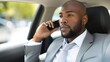 © mariiaplo - Confident African American Businessman Talking on Phone While in Car