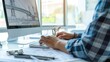 © Oulaphone - Architect man using computer for drawing bridge design at modern office.
