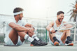 © SneakyPeakPoints/peopleimages.com - Friends, tennis and break with racket, laughing and happy for match with equipment, court and fitness for sports. Outdoor, team and game for people, men and joke for performance in field and funny