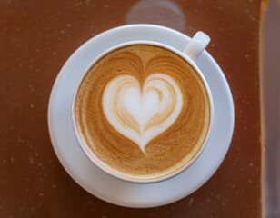 Top-Down View of Latte Art Heart Shape on Cappuccino with Steam Rising